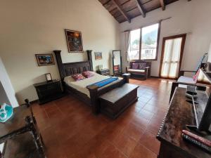 危地马拉安地瓜Amplia casa Antigua Guatemala con pérgola y jardín的一间卧室配有一张床和一个沙发