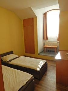 诺茨瓦约Panorama Hotel Noszvaj的一间卧室设有两张床和窗户。