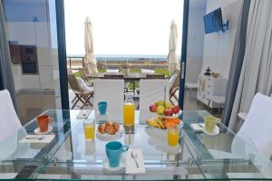 蓬塔穆赫雷斯Luxury Villa Punta Mujeres的玻璃桌,放上一碗水果和橙汁