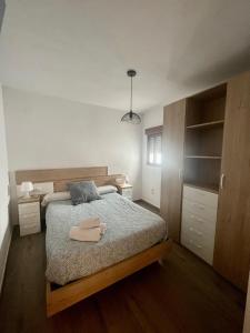 隆达Apartamentos - Naranja的一间卧室配有一张床和一张带毛巾的桌子