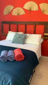 瓜鲁雅Pousada Suítes Sete Mares的一张带枕头的床和红色的墙壁