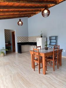 多明戈斯马丁斯Recanto da Roca的客厅配有木桌和椅子