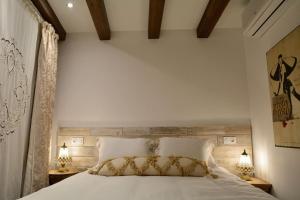滨海托萨Can Senio 1的一间卧室配有一张带两盏灯的大型白色床。