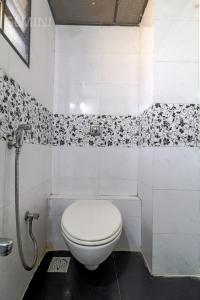 孟买Hotel Gemini的浴室铺有黑白瓷砖,设有白色卫生间。