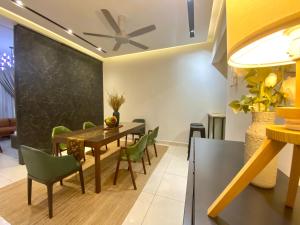 普特拉贾亚Luxury 2-Storey Terrace House near IOI City Mall Putrajaya的一间带桌子和绿色椅子的用餐室