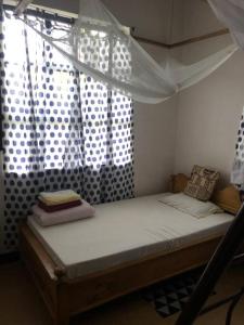 姆托瓦姆布The Hondo Hondo House, Mto wa Mbu的窗户客房内的一张带天蓬的床