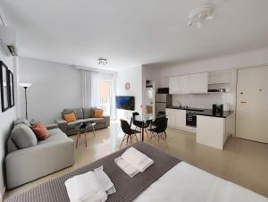 雅典Omorfokklisias Apartments by Verde的带沙发的白色客厅和厨房