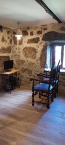 布拉加Casa do Carregal的石墙内的房间,配有桌椅
