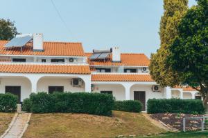 阿尔布费拉Apartamentos Vale de Carros by Umbral的屋顶上设有太阳能电池板的房子