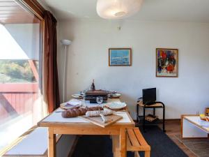 勒克比尔Apartment Lunik Orion-22 by Interhome的一间设有木桌的房间,上面有食物