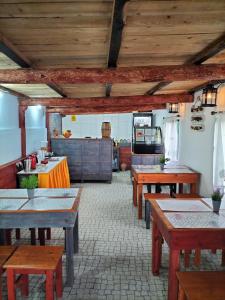 英雄港Alojamento Raminho dos Açores的一间带木桌的用餐室和一间厨房