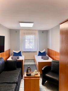 斯图加特M酒店的一间带两张床和一张沙发的客厅
