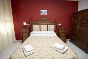 隆达圣女德洛斯雷耶斯酒店的一间卧室配有一张带两条白色毛巾的床