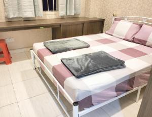 新山JB Austin Perdana Homestay@Simple Comfy For 11pax的一张床上有两个枕头的房间