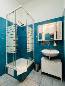 卢布尔雅那Apartments Katrca Ljubljana的蓝色的浴室设有水槽和淋浴