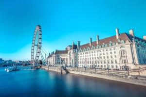 伦敦伦敦市政厅万豪酒店的一条有大建筑和摩天轮的河流