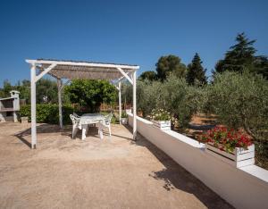 莫诺波利Porta Sugli Ulivi的花园内的野餐桌和凉亭