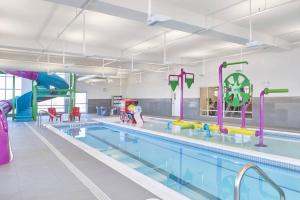 梅迪辛哈特TownePlace Suites by Marriott Medicine Hat的一个带水上公园的大型游泳池