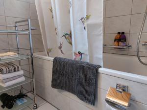 BnB Elsenerhaus的浴室设有淋浴帘,上面有鸟儿