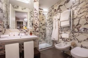 罗马辛尔帕里斯酒店的一间带水槽、卫生间和镜子的浴室