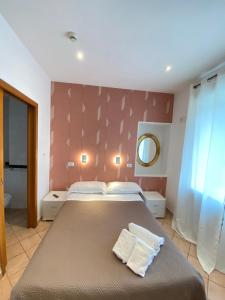 那不勒斯那不勒斯欧洲酒店的一间卧室配有一张大床和镜子