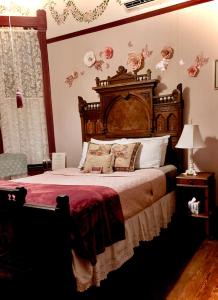 加尔维斯敦Coppersmith Inn Bed And Breakfast的一间卧室配有一张大床和木制床头板