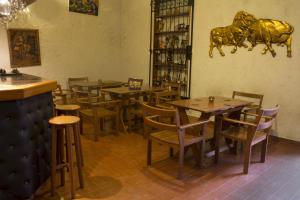 阿雷基帕努埃瓦西班牙旅馆的餐厅设有木桌和椅子,墙上挂着牛雕