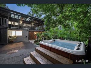 WarrandyteResort-style 4 bdrm home w pool, spa & billiards!的房屋的庭院里设有浴缸