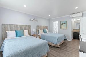 洛杉矶圣莫尼卡海滩海洋酒店的卧室设有两张蓝色和白色的床
