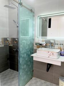 Bạc LiêuPhụng Hoàng Vũ的一间带玻璃淋浴和水槽的浴室