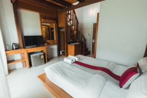 高兰Lanta Ray Bay Hotel的一间卧室配有一张大床和电视