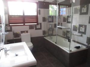 康提Sun Set Forest Villa的带浴缸、卫生间和盥洗盆的浴室