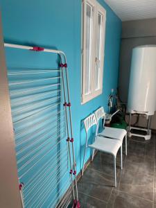 索勒尔堡« Le temps d’un instant » dépendance的一间设有两把椅子和蓝色墙壁的房间