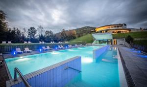 拉斯卡尔达斯Las Caldas by blau hotels的一座带椅子的大型游泳池和一座建筑