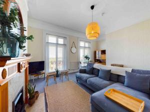 大雅茅斯Spacious apartment with Sea Views on Great Yarmouth Seafront的客厅配有蓝色的沙发和电视