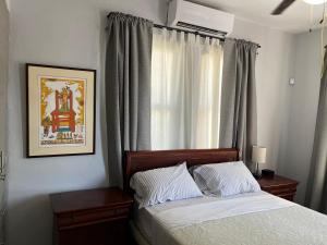 圣胡安拉埃斯坦西亚度假公寓的一间卧室配有床和带窗帘的窗户