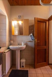 SillanoCasaGiulia的一间带水槽、镜子和门的浴室