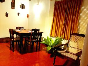 希克杜沃Coco Garden Villas的一间配备有桌椅和植物的餐厅