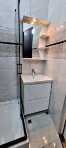 捷尔诺波尔Центр Апарт的浴室配有盥洗盆、镜子和浴缸