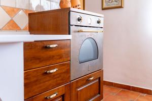 洛帕Salvija Apartments的厨房配有不锈钢烤箱和木制橱柜。