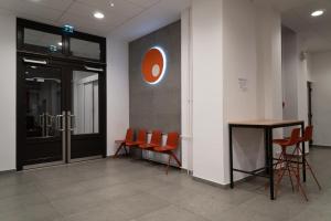 布达佩斯Equity Point Budapest的一个带橙色椅子和桌子的办公室大堂