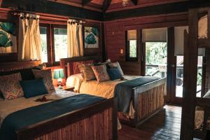 巴拉奥纳省圣克鲁斯Platon Ecolodge的一间带两张床和一张沙发的卧室