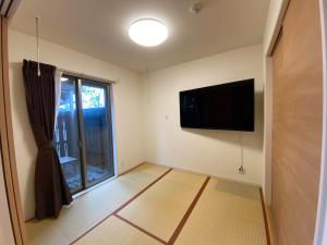KikuyoAirport Kikuyo Forest - Vacation STAY 14128的客厅配有平面电视和窗户。
