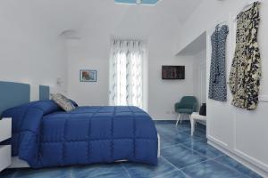 斯卡拉Amalfi Sea View的一间卧室配有蓝色的床,铺有蓝色的地板