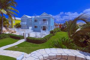 尼格瑞尔Stunning Ocean View的一座蓝色的大房子,前面有草坪