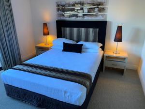 弗里曼特公园巷公寓的一间卧室配有一张大床,提供蓝色的床单和枕头