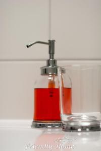 BrenigFriendly Home - Einzelappartement "Calm" Köln Bonn Phantasialand的装有红色液体的玻璃瓶