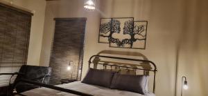 CarolinaRand Self-catering Accommodation的卧室配有一张床,墙上挂有两张照片