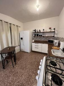 伊莎贝拉Playa y Campo Studio的厨房配有炉灶、桌子和冰箱。