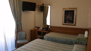 罗马特缇酒店的酒店客房,设有两张床和镜子